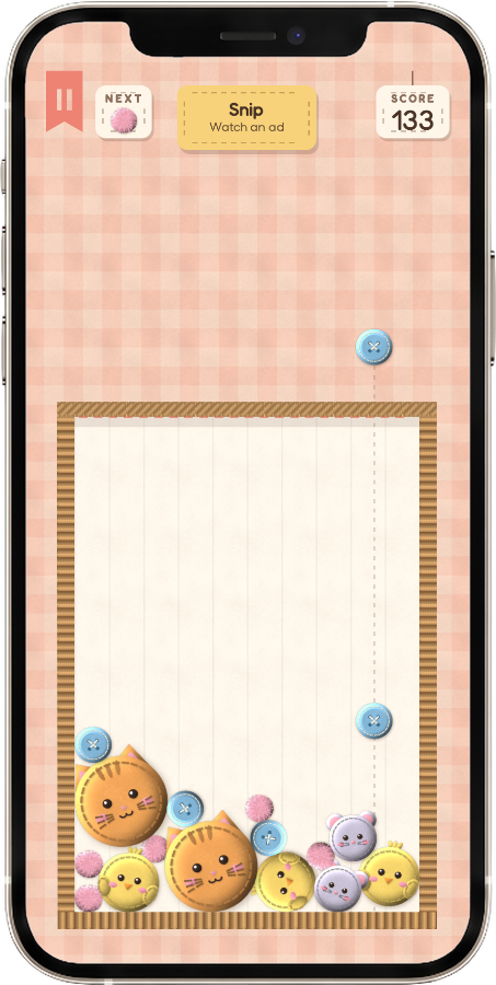 A Felt Drop game, with felt cats, chicks and buttons in a sewing basket, on a phone